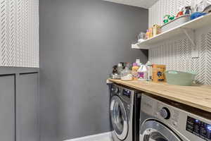 Laundry room featuring bar area and washer and clothes dryer