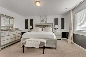 Carpeted bedroom with a textured ceiling