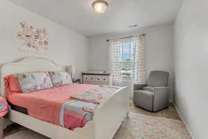 Carpeted bedroom with a textured ceiling