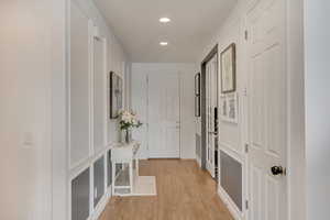 Hallway with light hardwood / wood-style floors