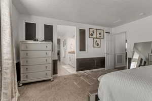 Carpeted bedroom with a textured ceiling