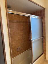 Bathroom with enclosed tub / shower combo