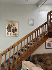 Stairway to loft, full bathroom and storage area