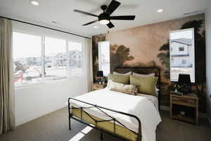 Carpeted bedroom with ceiling fan