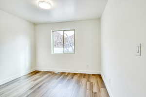 Spare room with light hardwood / wood-style floors