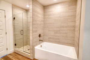 Bathroom featuring separate shower and tub and hardwood / wood-style floors