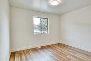 Empty room featuring light hardwood / wood-style flooring