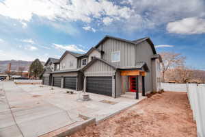 View of front of house with a garage and a mountain view