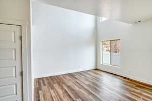 Spare room featuring wood-type flooring