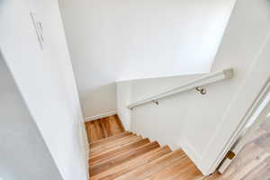 Staircase with hardwood / wood-style floors