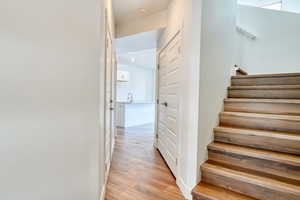 Stairway featuring sink and hardwood / wood-style flooring