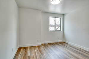 Unfurnished room with light hardwood / wood-style flooring