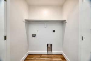 Laundry room featuring hookup for a washing machine, hookup for an electric dryer, and light wood-type flooring