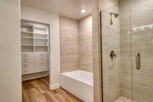 Bathroom with wood-type flooring and independent shower and bath