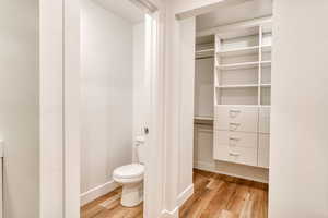 Bathroom with hardwood / wood-style flooring and toilet