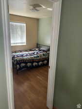 Bedroom with wood-type flooring and a textured ceiling