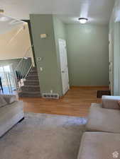 Living room featuring wood-type flooring and a textured ceiling