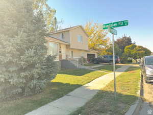 View of front facade featuring a garage and a front yard