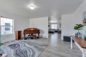 Interior space with light hardwood / wood-style flooring and a textured ceiling