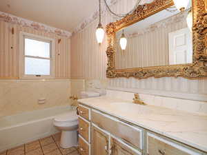 Bathroom featuring tile patterned floors, vanity, and toilet