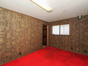 Spare room with carpet floors and a textured ceiling