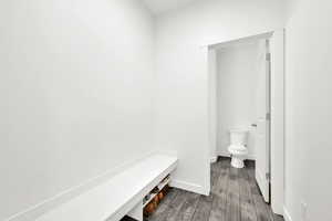 Bathroom featuring wood-type flooring and toilet