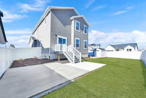 Back of property featuring a yard, a shed, and a patio