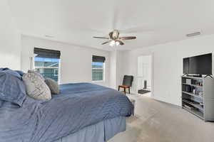 Carpeted bedroom with ceiling fan