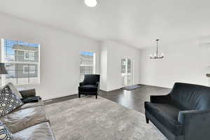 Living room featuring dark hardwood / wood-style floors and an inviting chandelier