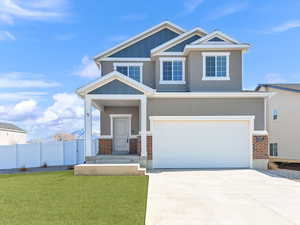 View of front of house with a garage and a front yard