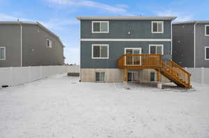 Rear view of house featuring a wooden deck