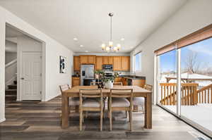 Dining area featuring a notable chandelier, hardwood / wood-style floors, and sink