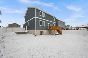 Back of house featuring a wooden deck