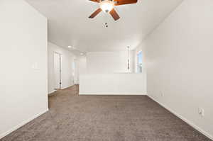 Spare room featuring ceiling fan and carpet flooring