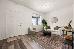 Living room with dark hardwood / wood-style flooring