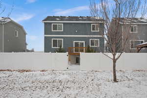 View of snow covered rear of property