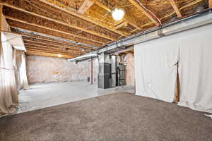 Basement featuring heating unit