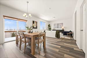 Dining room featuring dark hardwood / wood-style flooring and a chandelier