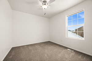 Spare room with carpet flooring and ceiling fan