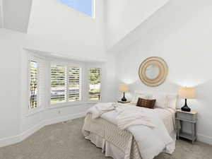 Bedroom with a vaulted ceiling and carpet floors