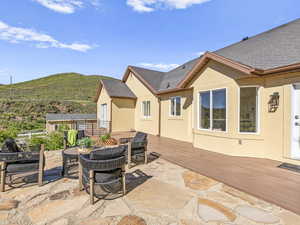 View of patio featuring an outdoor hangout area and a deck with mountain view