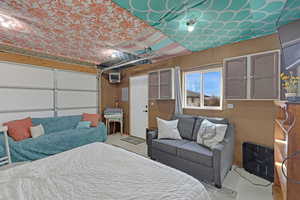 Bedroom featuring an AC wall unit