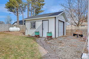 View of outbuilding featuring a garage and a yard