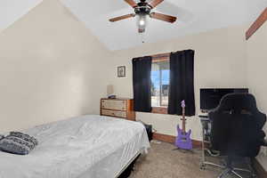 Bedroom featuring lofted ceiling, carpet, and ceiling fan