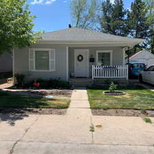 Bungalow featuring a porch and a front lawn