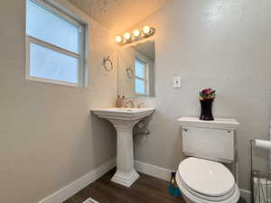 Bathroom with toilet and hardwood / wood-style floors