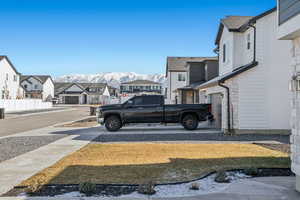 View of yard with a garage and a mountain view