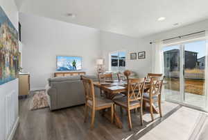 Dining room with lofted ceiling and dark hardwood / wood-style floors