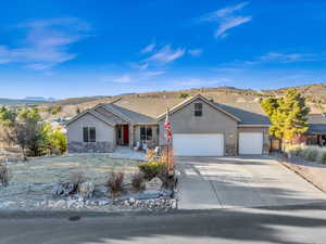 Ranch-style home featuring a garage and a mountain view