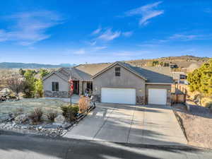 Ranch-style home featuring a garage and a mountain view